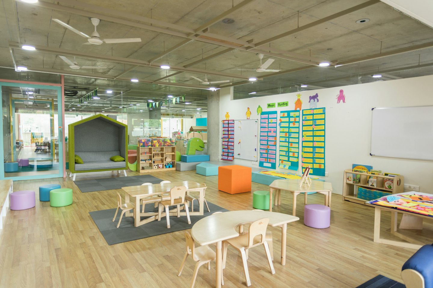 Children's playroom with modern furniture and educational displays.